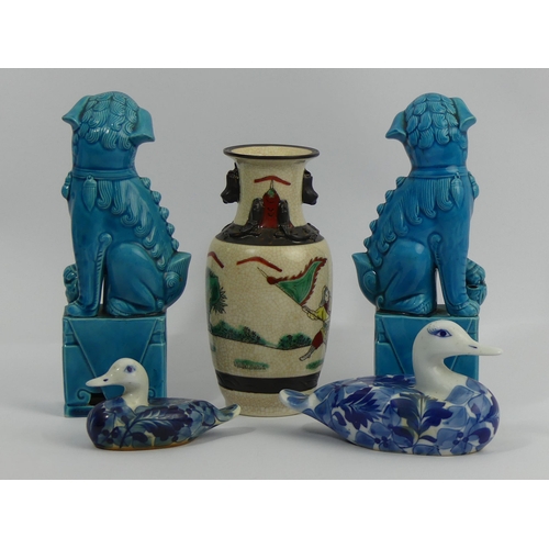 310A - A pair of Chinese turquoise glazed temple lions, a Chinese crackle ware warrior vase and two blue & ... 