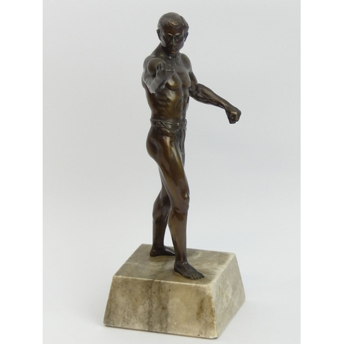 375B - A pre-war German bronze figure of an athlete on a grey marble base. 29cm. UK Postage £16.