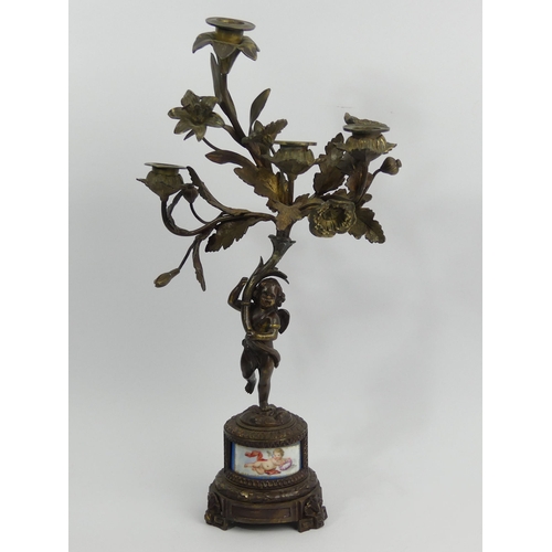 375C - 19th century bronze figural candelabrum with an inset porcelain panel. 46cm high. UK Postage £20.