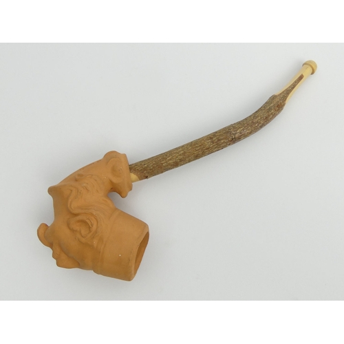 407 - Unsmoked teracotta pipe bowl in the shape of a Turks head, marked DENDO, with a cherry wood stem. UK... 