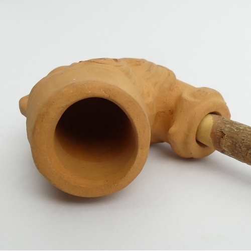 407 - Unsmoked teracotta pipe bowl in the shape of a Turks head, marked DENDO, with a cherry wood stem. UK... 