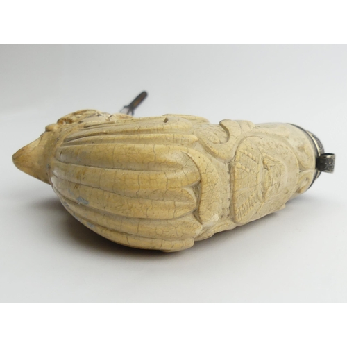 451 - A large meerschaum elbow pipe carved with a dog finial at the rear and a shield with a medieval face... 