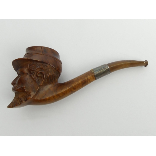 465 - A French carved briar of a head of a soldier with a vulcanite mouthpiece and a metal mount, 15cm. UK... 