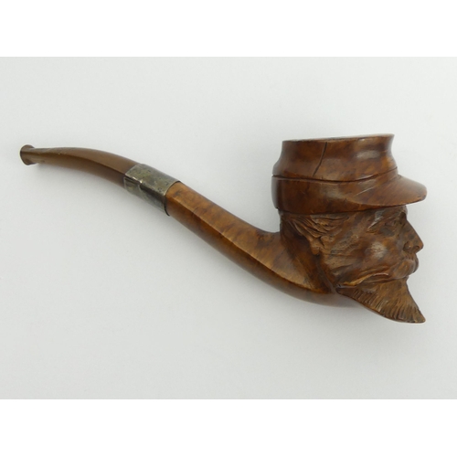 465 - A French carved briar of a head of a soldier with a vulcanite mouthpiece and a metal mount, 15cm. UK... 