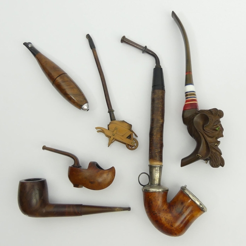 467 - Six various smoking items including a carved boxwood cheroot holder in the shape of wheelbarrow, 17c... 