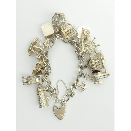 27 - Sterling silver charm bracelet, 74.9 grams.