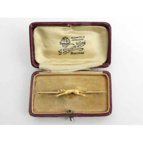 36 - 9ct gold dog design bar brooch, 3 grams, 5.5cm.