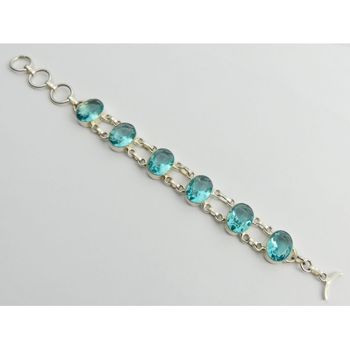 85 - Sterling silver blue stone set bracelet, 25.4 grams, 20cm x 16.2mm.