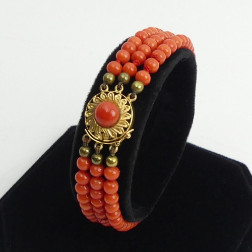 92 - Coral three strand bead bracelet with an 18ct gold clasp, 14.1 grams, 17.5cm x 1.1cm.