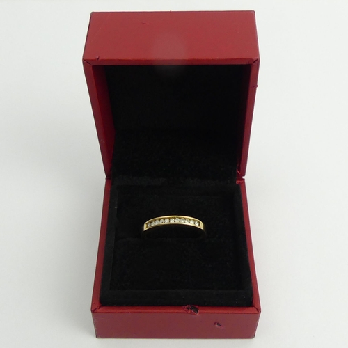 121 - 18ct gold channel set eleven stone diamond ring 2 grams, 2.8mm, size N.