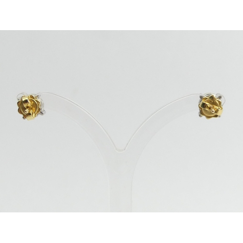 125D - A pair of 18ct diamond stud earrings, each approx. 1 carat, 2.8 grams, 6.4mm diameter.