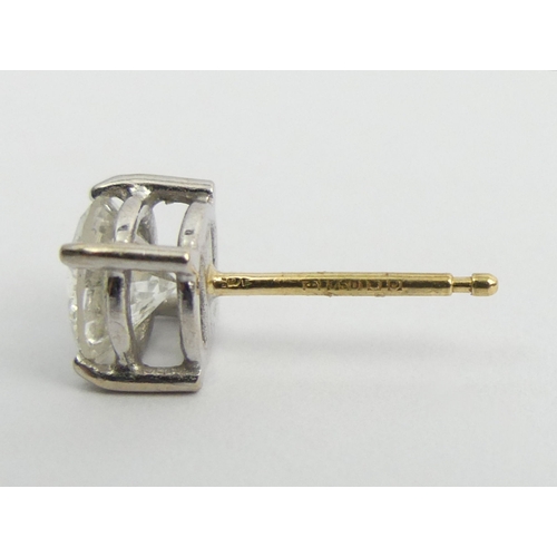 125D - A pair of 18ct diamond stud earrings, each approx. 1 carat, 2.8 grams, 6.4mm diameter.