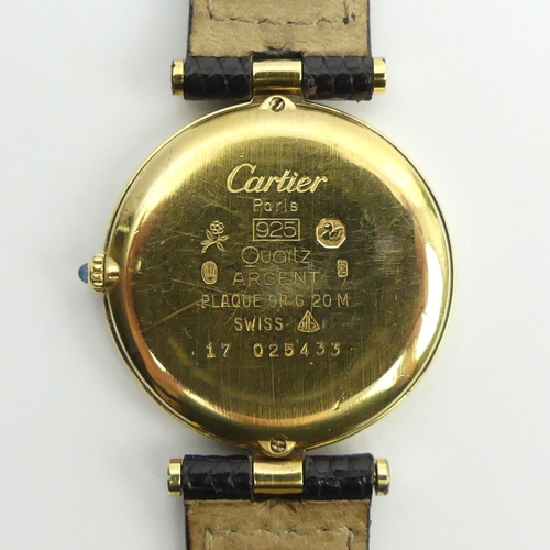 128 - Must De Cartier silver vermeil quartz watch on a black leather Cartier strap, 32mm.