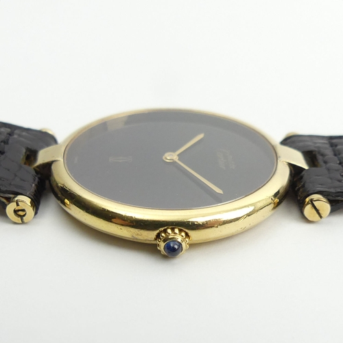 128 - Must De Cartier silver vermeil quartz watch on a black leather Cartier strap, 32mm.