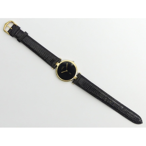 128 - Must De Cartier silver vermeil quartz watch on a black leather Cartier strap, 32mm.