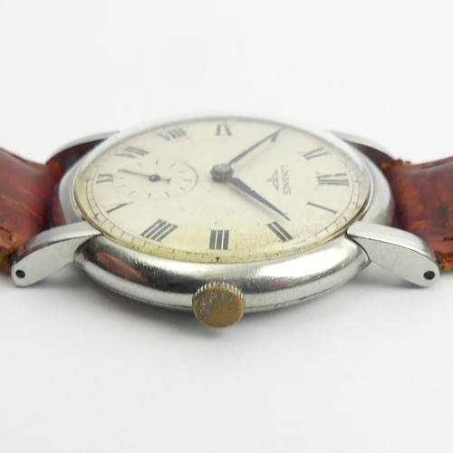 136 - Longines manual wind gents watch on a leather strap, 37.5mm inc. button.