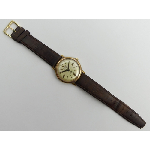 160F - Allaine 30 jewel automatic gold tone gents watch on a leather strap, 36mm wide.