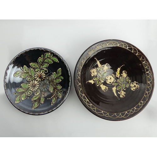 344 - Two continental floral slip-ware pottery bowls C.1900, largest 33.5cm x 10cm.