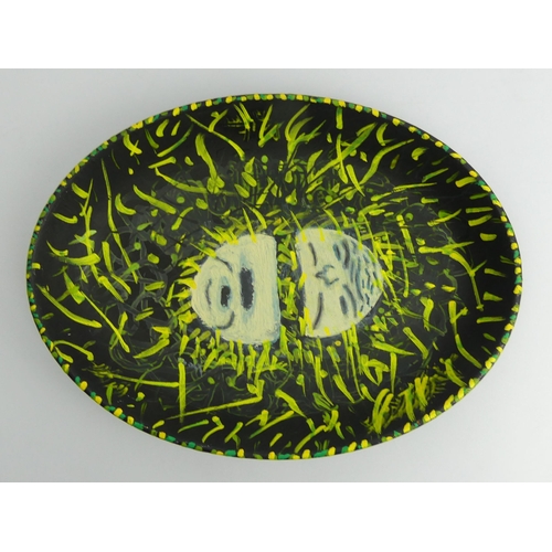 389 - Hand painted oval pottery dish, insect design, signed J.P. 73 probably John Piper, 37cm x 27.5cm.