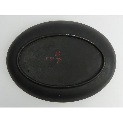 389 - Hand painted oval pottery dish, insect design, signed J.P. 73 probably John Piper, 37cm x 27.5cm.