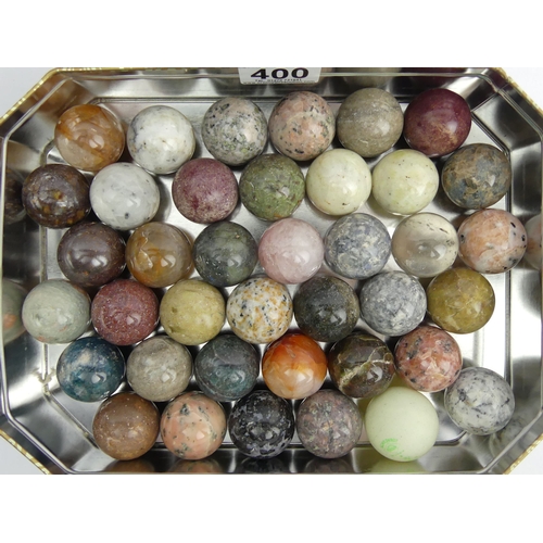 400 - A collection of 38 polished semi-precious stone balls, 34mm diameter.