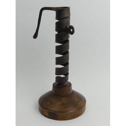 404 - 19th Century iron and wood spiral courting candle holder on a later base, 22cm.