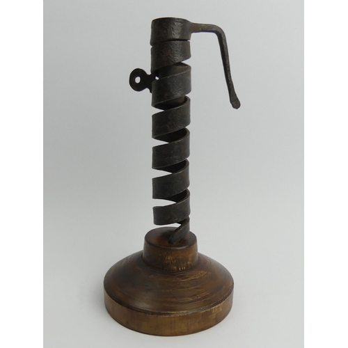 404 - 19th Century iron and wood spiral courting candle holder on a later base, 22cm.