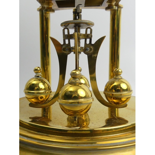 408 - Brass anniversary clock with an enamel dial and glass dome, 30cm.