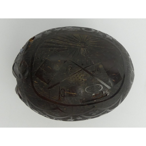 449 - Spanish colonial carved coconut money box decorated with a bull fighting and other signs.