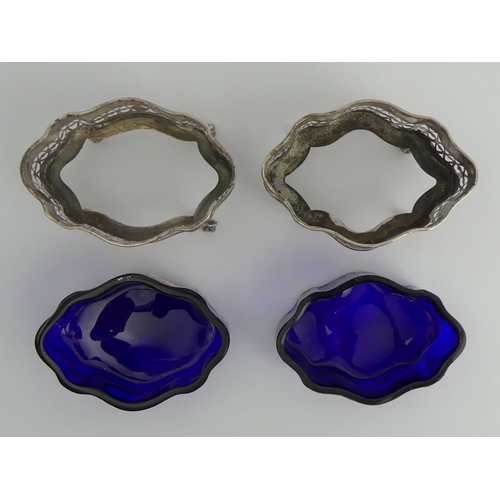 170 - A pair of silver salts, Chester 1898, with blue glass liners, 91 grams, 9cm x 5cm.