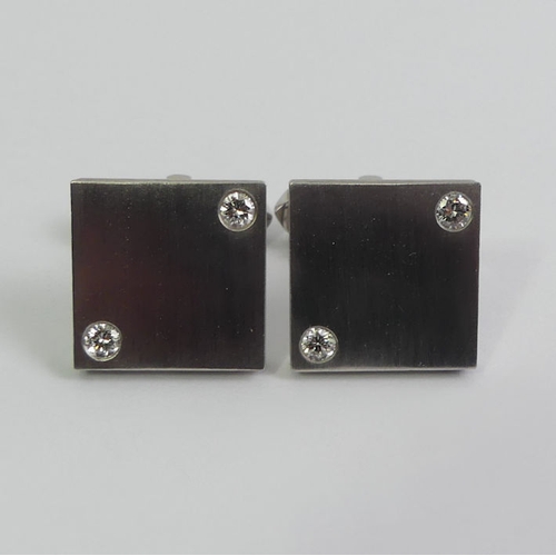 114 - A pair of Cartier platinum and diamond cufflinks in a fitted case, 32.5 grams, 19.9mm square.