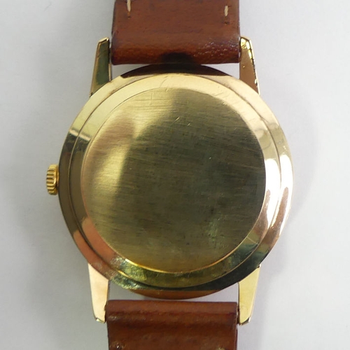 138 - Omega 9ct gold automatic date adjust gents watch on a leather strap, 34mm inc. button.
Condition Rep... 