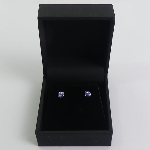 55 - A pair of 18ct white gold tanzanite earrings, 4mm in diameter.