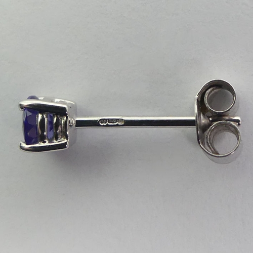 55 - A pair of 18ct white gold tanzanite earrings, 4mm in diameter.