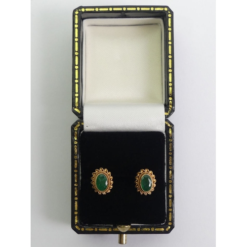 79 - A pair of 9ct gold emerald earrings, 1.2 grams.