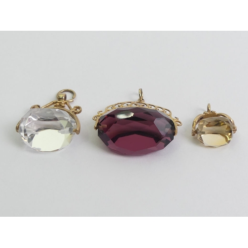 83 - Three 9ct gold stone set swivel fobs, 17.5 grams.