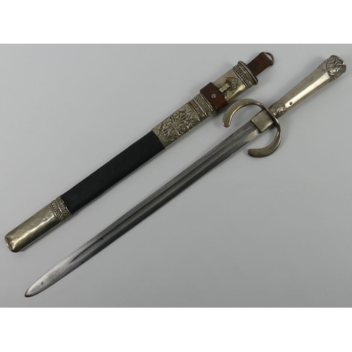 249 - An Arabic bayonet in scabbard with white metal fittings, blade 42cm.