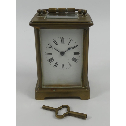 299 - Early 1900's brass carriage clock and key. 14.5cm high.