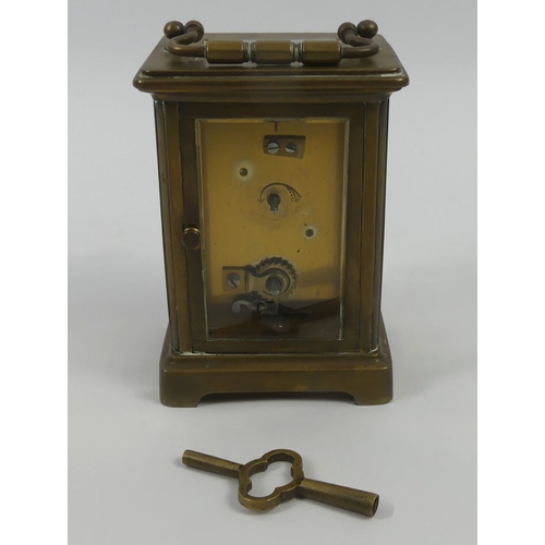 299 - Early 1900's brass carriage clock and key. 14.5cm high.