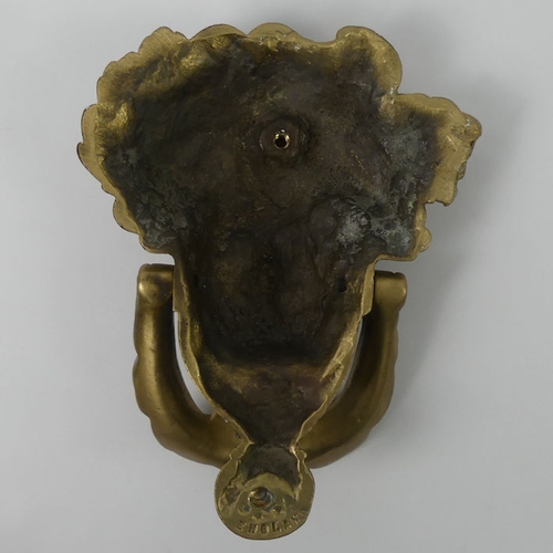 317 - Ornate brass door knocker in the form of a classical head, 19cm x 15cm.