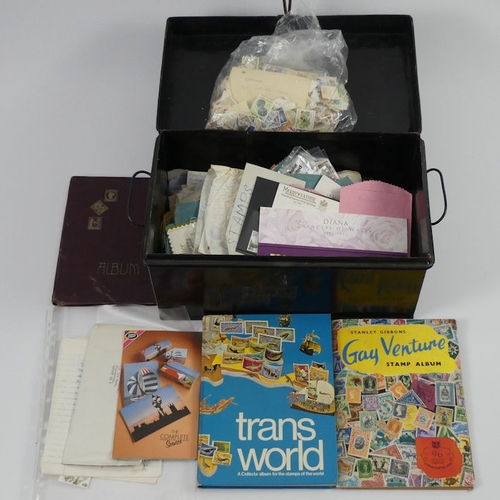 324 - An old tin of stamps and albums, 39cm x 22cm x 22cm.