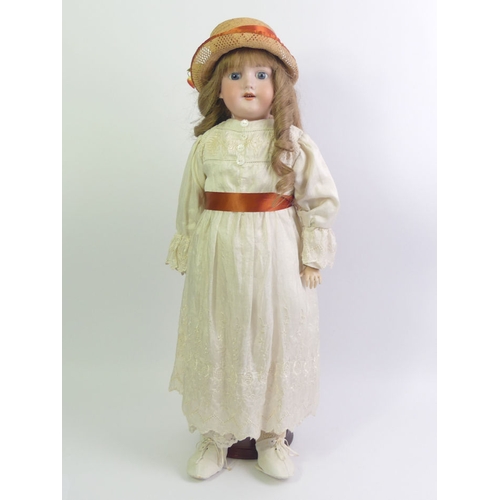 337 - An Armand Marseille bisque head doll number 390. 58cm tall.