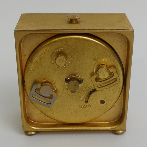 134 - A gilt metal travel alarm clock with a Swiss eight day movement. 5.8 x 6.6 cm.
Condition report: In ... 