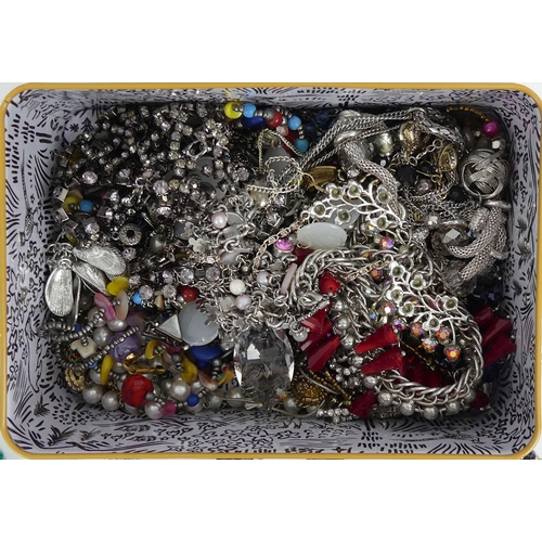 13 - A tin of good costume jewellery including crystal bangles.