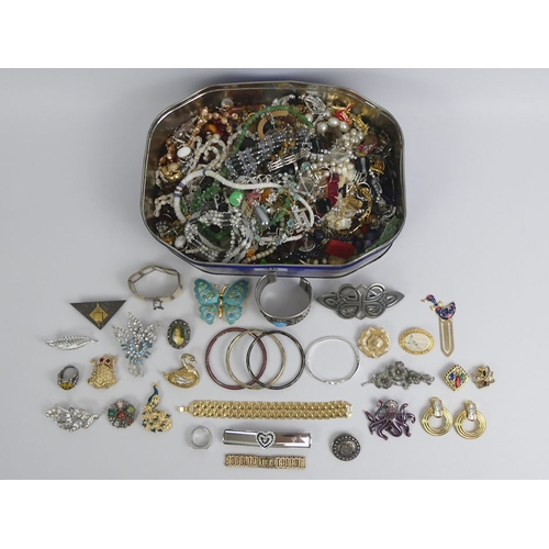 28 - A tin of mixed costume jewellery, including a cloisonne bangle and an enamelled butterfly.