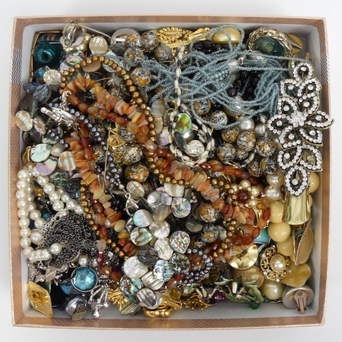 8 - A box of costume jewellery including stone set earrings and brooches along with a carnelian necklace... 