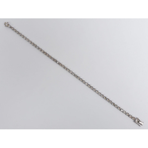 82 - 18ct white gold diamond line bracelet, 6 grams, 19cm x 3.45mm.