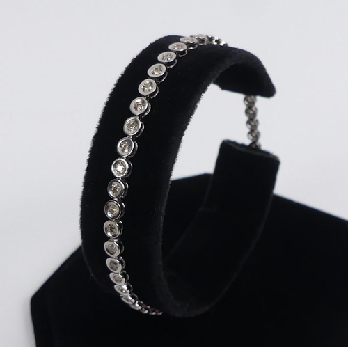 82 - 18ct white gold diamond line bracelet, 6 grams, 19cm x 3.45mm.