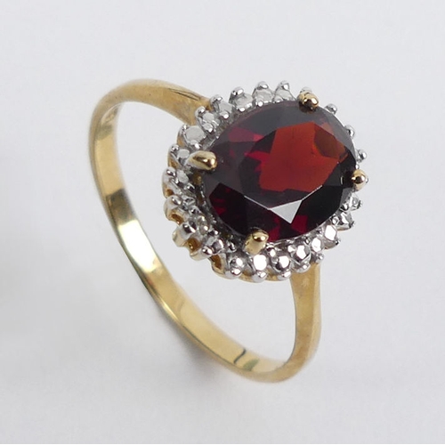 88 - 9ct gold garnet and diamond ring, 2.1 grams, 11.9mm, size P.