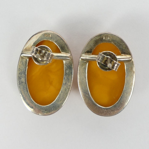 93 - Silver and butterscotch amber pendant and chain with a similar pair of earrings, pendant 55mm.